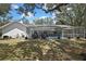 View of the in-ground screened pool and back yard of this house with a new roof at 7233 Royal Oak Dr, Spring Hill, FL 34607