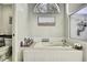 A bright bathroom features a tiled tub and toilet with a decorative window at 7233 Royal Oak Dr, Spring Hill, FL 34607