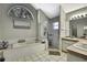 Neutral toned bathroom features a large shower and tub with a picturesque window at 7233 Royal Oak Dr, Spring Hill, FL 34607