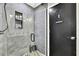 Updated bathroom featuring a glass-enclosed shower with gray tile and modern vanity at 7233 Royal Oak Dr, Spring Hill, FL 34607