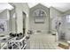 Bright bathroom showcasing a tiled tub, glass shower, and decorative window at 7233 Royal Oak Dr, Spring Hill, FL 34607