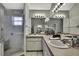 Bathroom featuring a shower with glass door and and sinks, and large mirrors at 7233 Royal Oak Dr, Spring Hill, FL 34607