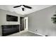 Gray bedroom featuring a ceiling fan, a dark wood dresser and an interior door at 7233 Royal Oak Dr, Spring Hill, FL 34607