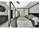 Well-lit bedroom featuring a four-poster bed, modern gray decor, and a tranquil ambiance at 7233 Royal Oak Dr, Spring Hill, FL 34607