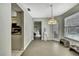 Bright dining area with a modern pendant light and a view into the living room at 7233 Royal Oak Dr, Spring Hill, FL 34607
