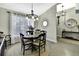 Bright dining room featuring modern light fixture, round table and jute rug at 7233 Royal Oak Dr, Spring Hill, FL 34607