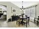 Stylish dining area featuring a round table, straw chairs, modern chandelier and a neutral color palette at 7233 Royal Oak Dr, Spring Hill, FL 34607