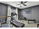 Home gym featuring a ceiling fan, treadmill, bike, and weight bench, perfect for fitness enthusiasts at 7233 Royal Oak Dr, Spring Hill, FL 34607