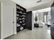 Hallway featuring built-in bookshelves that leads to a sun-filled sitting room with neutral decor at 7233 Royal Oak Dr, Spring Hill, FL 34607