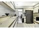 Bright kitchen with white cabinetry and view of dining room at 7233 Royal Oak Dr, Spring Hill, FL 34607