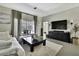 Comfortable living room showcasing neutral decor, a white sofa, and a view of the pool area at 7233 Royal Oak Dr, Spring Hill, FL 34607