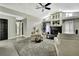 Spacious living room features high ceilings, fan, fireplace, and plush gray carpeting at 7233 Royal Oak Dr, Spring Hill, FL 34607