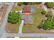 Aerial view of two single-Gathering homes, one with a pool and a large lawn at 7270 Nightwalker Rd, Weeki Wachee, FL 34613