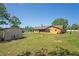 A spacious backyard with a storage shed, AC unit, and lush lawn at 7270 Nightwalker Rd, Weeki Wachee, FL 34613