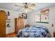 Bedroom with hardwood floors, ceiling fan and natural lighting through the window at 7270 Nightwalker Rd, Weeki Wachee, FL 34613