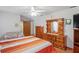 Bright bedroom with a ceiling fan, full dresser with a mirror, and neutral paint at 7270 Nightwalker Rd, Weeki Wachee, FL 34613