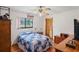 Cozy bedroom with hardwood floors, a ceiling fan, and natural lighting at 7270 Nightwalker Rd, Weeki Wachee, FL 34613