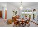 Formal dining room bathed in natural light, complemented by elegant chandelier and neutral decor at 7270 Nightwalker Rd, Weeki Wachee, FL 34613