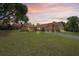 Exterior view of a well-maintained home with a long driveway and green lawn at 7270 Nightwalker Rd, Weeki Wachee, FL 34613