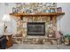 Close-up of a stone fireplace with a wooden mantel and decorative accents at 7270 Nightwalker Rd, Weeki Wachee, FL 34613