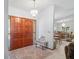 Elegant foyer featuring a chandelier, double doors, and a view into the dining room at 7270 Nightwalker Rd, Weeki Wachee, FL 34613