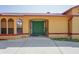 Home's inviting front entrance with striking green double doors and decorative accents at 7270 Nightwalker Rd, Weeki Wachee, FL 34613