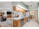 Traditional kitchen featuring wood cabinetry and a breakfast bar, offering seamless flow to dining area at 7270 Nightwalker Rd, Weeki Wachee, FL 34613