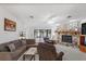 Comfortable living room with stone fireplace, plush seating, and sliding doors to outdoor space at 7270 Nightwalker Rd, Weeki Wachee, FL 34613