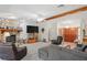 Open living room with a stone fireplace, plush seating, and a view of the foyer at 7270 Nightwalker Rd, Weeki Wachee, FL 34613