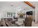 Spacious living room with a stone fireplace, plush seating, and a large TV at 7270 Nightwalker Rd, Weeki Wachee, FL 34613