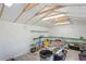Bright interior of a shed featuring exposed rafters, white walls, and shelving at 7270 Nightwalker Rd, Weeki Wachee, FL 34613