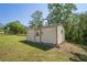 Exterior of a storage shed with a small garden and painted door at 7270 Nightwalker Rd, Weeki Wachee, FL 34613