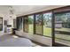 Enclosed sunroom featuring multiple windows and outdoor views at 7270 Nightwalker Rd, Weeki Wachee, FL 34613