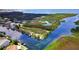 Picturesque aerial view of canal-front homes with docks, surrounded by lush greenery and tranquil waters at 7300 Southwind Dr, Hudson, FL 34667