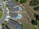 An aerial view of a backyard with an in-ground pool, patio, and partially grassed yard surrounded by a white fence at 733 Old Windsor Way, Spring Hill, FL 34609
