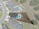 A home with an in-ground pool, patio, and partially grassed yard surrounded by a white fence is outlined in red at 733 Old Windsor Way, Spring Hill, FL 34609