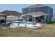 Aerial view of the backyard oasis with pool, outdoor kitchen, pergola, and patio at 733 Old Windsor Way, Spring Hill, FL 34609