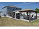 A spacious backyard has a pool, kitchen, outdoor seating and gazebo area at 733 Old Windsor Way, Spring Hill, FL 34609