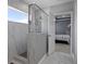 Contemporary bathroom with a glass shower and decorative wall and floor tiling at 733 Old Windsor Way, Spring Hill, FL 34609