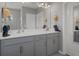 Elegant bathroom with double sinks, gray cabinets, and a modern faucet fixture at 733 Old Windsor Way, Spring Hill, FL 34609