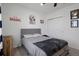 Well-lit bedroom featuring a cozy bed, baseball decor and a neutral wall decor at 733 Old Windsor Way, Spring Hill, FL 34609