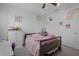 Bright bedroom with bed and lilac accents, decorated with playful decorations to create a cozy atmosphere for  at 733 Old Windsor Way, Spring Hill, FL 34609