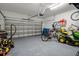 Spacious garage with epoxy flooring, overhead door, and ample room for storage and vehicles at 733 Old Windsor Way, Spring Hill, FL 34609