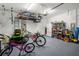 Well-organized garage featuring overhead storage racks and plenty of space for tools and equipment at 733 Old Windsor Way, Spring Hill, FL 34609