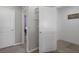 Hallway with white doors and neutral walls, leading to various rooms and spaces within the house at 733 Old Windsor Way, Spring Hill, FL 34609