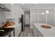 Stylish kitchen features stainless appliances, tiled backsplash, and a quartz island perfect for cooking and dining at 733 Old Windsor Way, Spring Hill, FL 34609