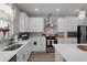 Well-lit kitchen boasts stainless appliances, sleek countertops, tiled backsplash, and ample cabinet space at 733 Old Windsor Way, Spring Hill, FL 34609
