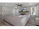 Open living space with an over sized sofa and an electric fireplace and mounted tv at 733 Old Windsor Way, Spring Hill, FL 34609