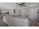 Open living space with an over sized sofa, ceiling fan, and stairs to the second floor at 733 Old Windsor Way, Spring Hill, FL 34609