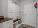 Mudroom with built-in bench, cubbies, storage, and convenient access to the home's interior at 733 Old Windsor Way, Spring Hill, FL 34609